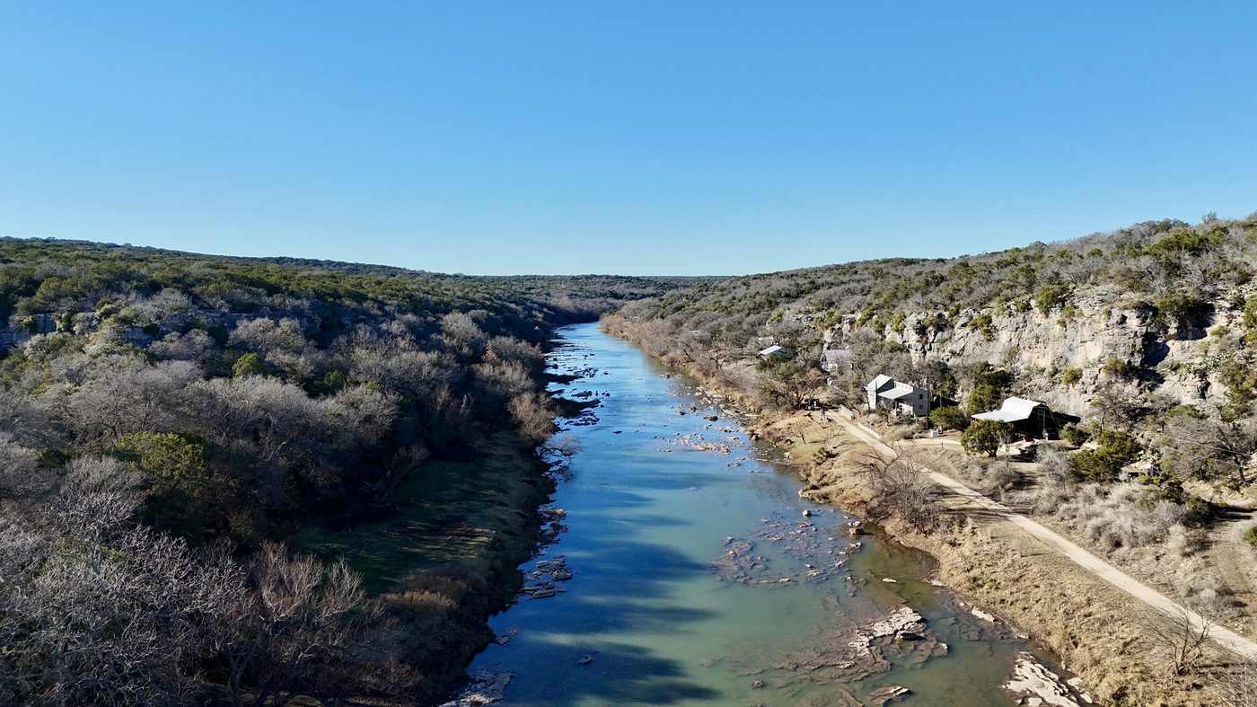 Aerial view of the Colorado River canyon with the cottage visible on the right bank
